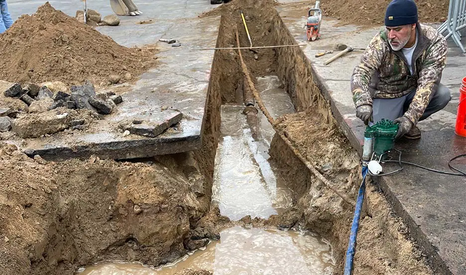 worker replacing gas and water pipes