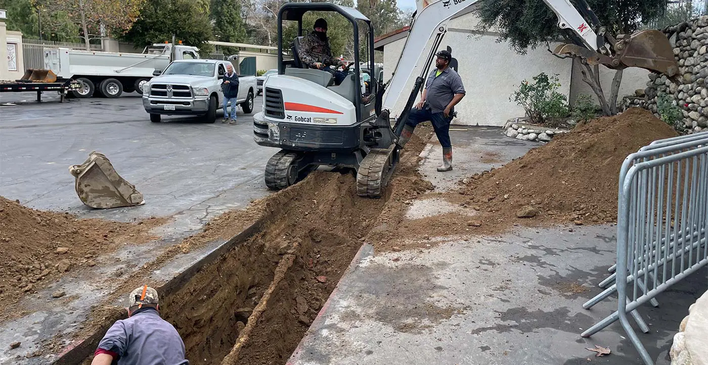 workers digging out sections of concrete