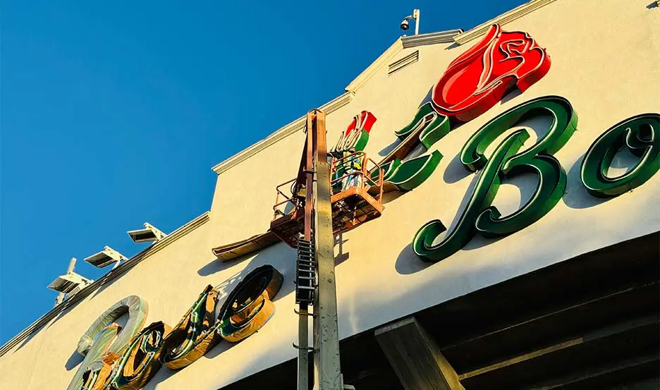 worker refurbishing historic marquee sign