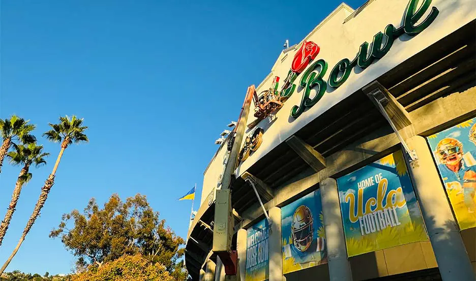 worker refurbishing historic marquee sign